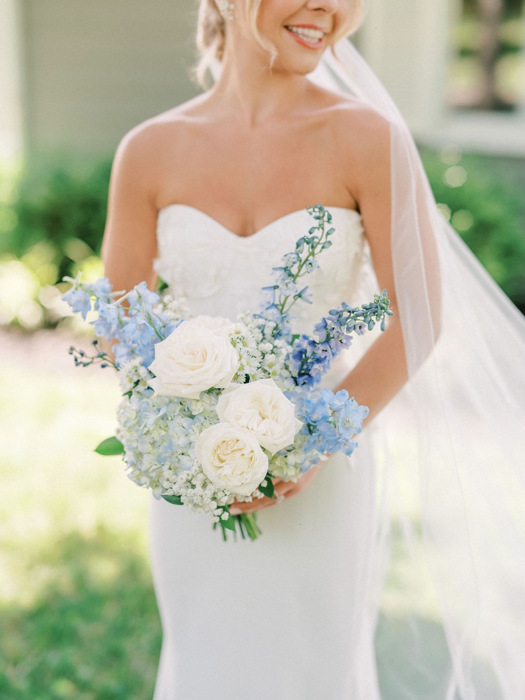 Floral archway at entrance of outdoor wedding